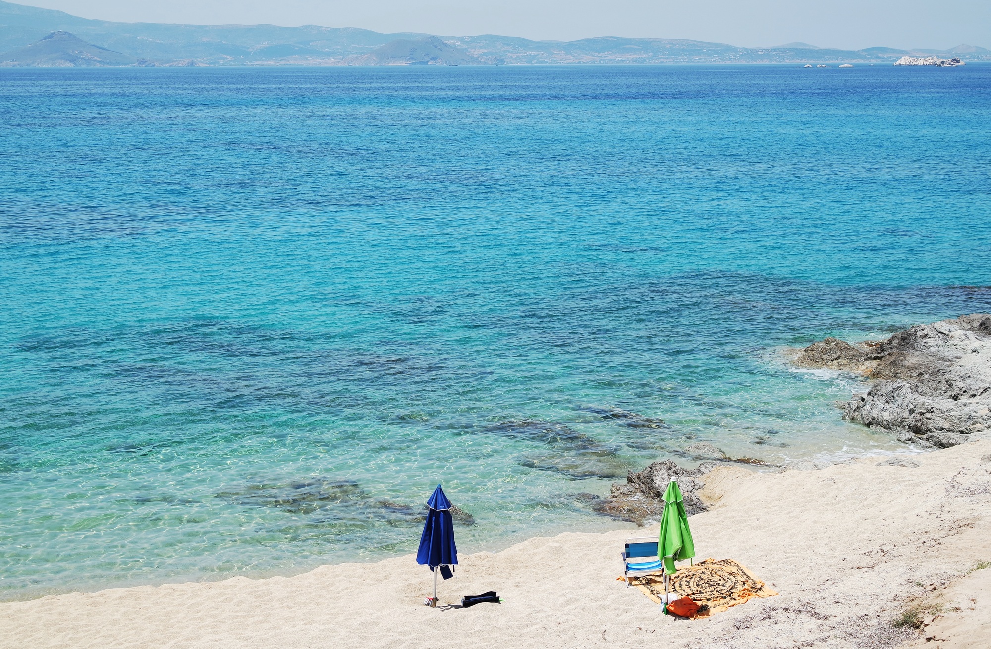 Summer scene at a white sand beach on Naxos island, Greece.