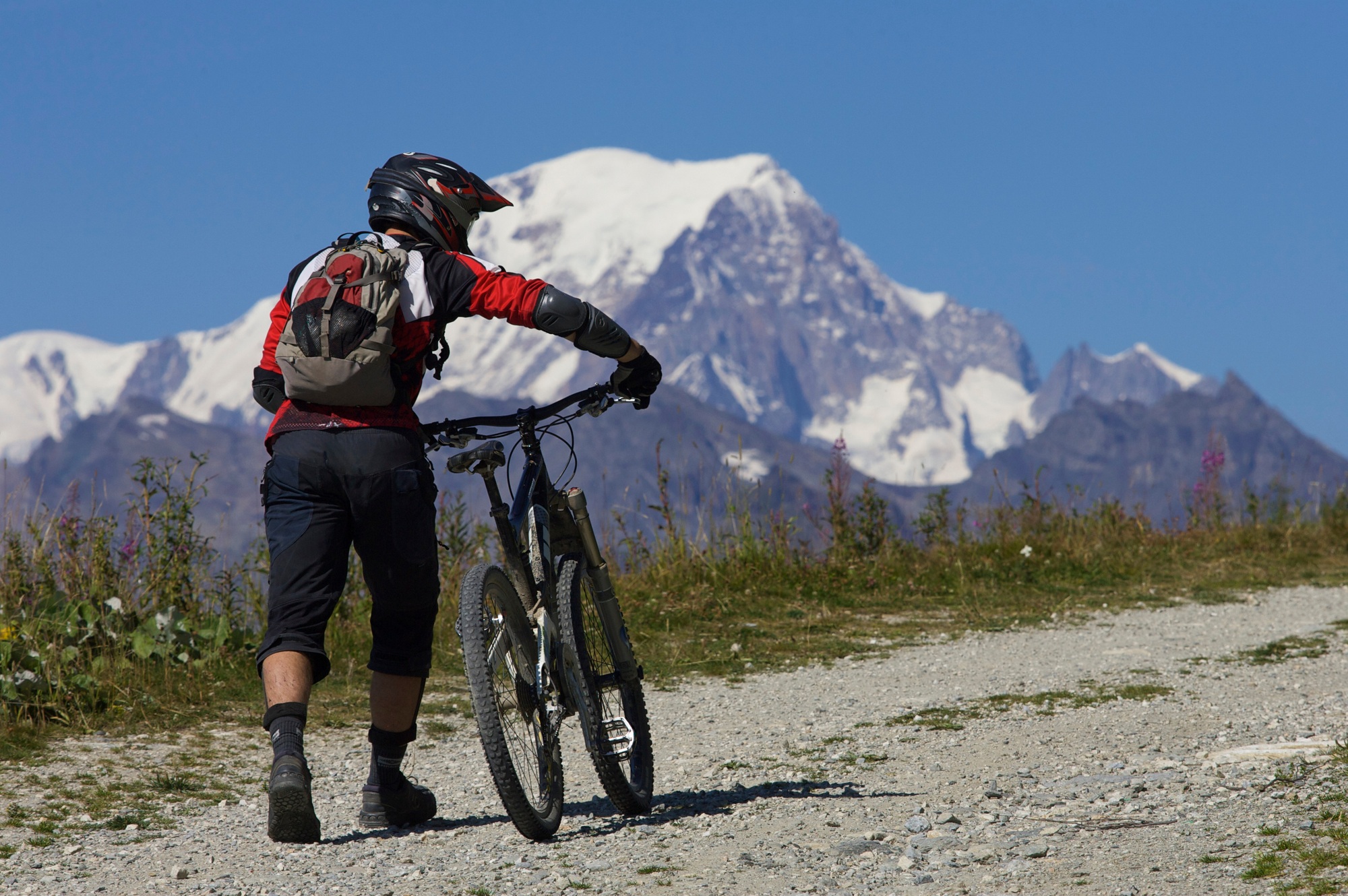 Mountain biker pushing his bike